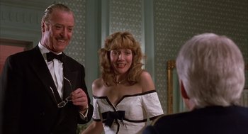 Movie still from “Dirty Rotten Scoundrels” (1988), directed by Frank Oz – A man and a woman in a black and white dress; Medium shot, Over the shoulder angle