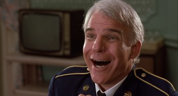 Movie still from “Dirty Rotten Scoundrels” (1988), directed by Frank Oz – An older man in a military uniform is laughing; Close Up shot, Low angle