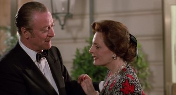 Movie still from “Dirty Rotten Scoundrels” (1988), directed by Frank Oz – An older man and a younger woman in formal wear; Close Up shot, Over the shoulder angle