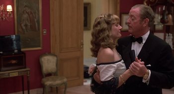 Movie still from “Dirty Rotten Scoundrels” (1988), directed by Frank Oz – A man and a woman dancing together in a room; Medium shot, Over the shoulder angle