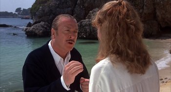 Movie still from “Dirty Rotten Scoundrels” (1988), directed by Frank Oz – A man and a woman talking in front of a body of water; Close Up shot, Over the shoulder angle