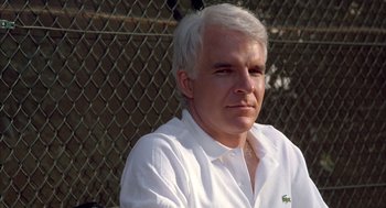 Movie still from “Dirty Rotten Scoundrels” (1988), directed by Frank Oz – A person wearing a white shirt; Close Up shot, Over the shoulder angle