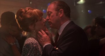 Movie still from “Dirty Rotten Scoundrels” (1988), directed by Frank Oz – A man and a woman are kissing in a room; Close Up shot, Low angle
