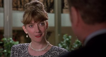 Movie still from “Dirty Rotten Scoundrels” (1988), directed by Frank Oz – A person wearing a necklace; Close Up shot, Over the shoulder angle