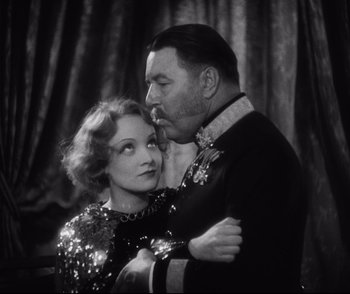 Movie still from “Dishonored” (1931), directed by Josef von Sternberg – An old photo of a man and a woman hugging; Close Up shot, Low angle