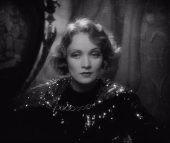 Movie still from “Dishonored” (1931), directed by Josef von Sternberg – A black - and - white photo of a woman in a sequined dress; Close Up shot, Low angle