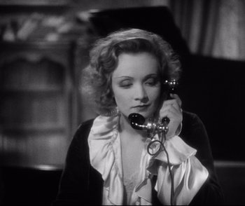 Movie still from “Dishonored” (1931), directed by Josef von Sternberg – A woman talking on a phone while sitting down; Close Up shot, High angle