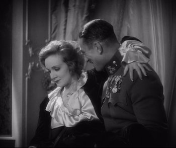 Movie still from “Dishonored” (1931), directed by Josef von Sternberg – A man and a woman sitting next to each other; Medium shot, Over the shoulder angle