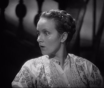 Movie still from “Dishonored” (1931), directed by Josef von Sternberg – A black and white photo of a woman with a braid; Close Up shot, High angle