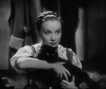 Movie still from “Dishonored” (1931), directed by Josef von Sternberg – A woman holding a black cat in a black and white photo; Close Up shot, High angle