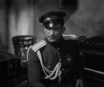 Movie still from “Dishonored” (1931), directed by Josef von Sternberg – A black and white photo of a man in a uniform; Medium shot, High angle