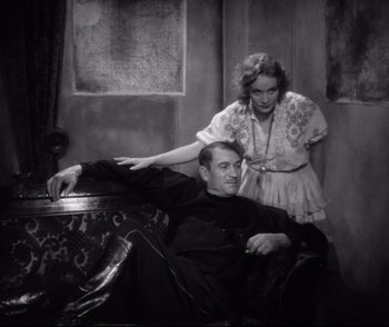 Movie still from “Dishonored” (1931), directed by Josef von Sternberg – A man and a woman sitting on a couch; Medium shot, Low angle