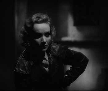 Movie still from “Dishonored” (1931), directed by Josef von Sternberg – A black and white photo of a woman in a leather jacket; Close Up shot, Over the shoulder angle