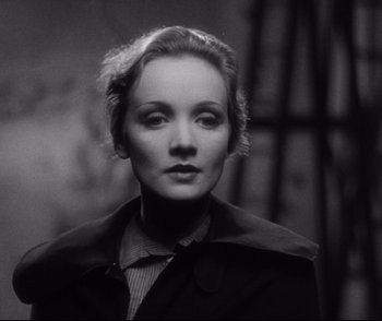 Movie still from “Dishonored” (1931), directed by Josef von Sternberg – A black - and - white photo of a woman in a jacket; Close Up shot, Low angle