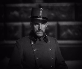 Movie still from “Dishonored” (1931), directed by Josef von Sternberg – A black and white photo of a man in a uniform; Close Up shot, Low angle