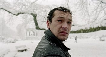 Movie still from “Distant” (2002), directed by Nuri Bilge Ceylan – A person wearing a jacket in the snow; Close Up shot, Low angle