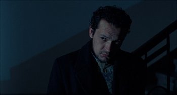 Movie still from “Distant” (2002), directed by Nuri Bilge Ceylan – A man in a black jacket is looking at the camera; Close Up shot, Low angle