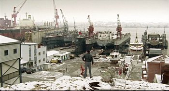 Movie still from “Distant” (2002), directed by Nuri Bilge Ceylan – A man standing on the roof of a building; Extreme Wide shot, High angle