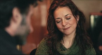 Movie still from “Distant” (2002), directed by Nuri Bilge Ceylan – A person with long red curly hair; Close Up shot, Over the shoulder angle