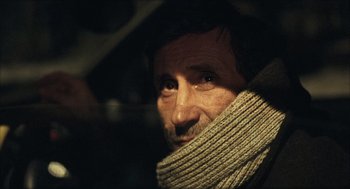 Movie still from “Distant” (2002), directed by Nuri Bilge Ceylan – A person wearing a scarf; Close Up shot, Over the shoulder angle