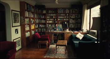Movie still from “Distant” (2002), directed by Nuri Bilge Ceylan – A man sitting at a desk in front of a computer in a library; Wide shot, High angle