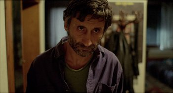 Movie still from “Distant” (2002), directed by Nuri Bilge Ceylan – A person wearing a shirt; Close Up shot, Over the shoulder angle