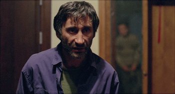 Movie still from “Distant” (2002), directed by Nuri Bilge Ceylan – A person wearing a purple shirt; Close Up shot, Low angle