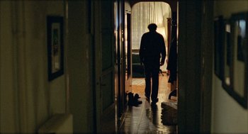 Movie still from “Distant” (2002), directed by Nuri Bilge Ceylan – An old man walking down the hall of a house; Wide shot, Low angle