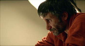 Movie still from “Distant” (2002), directed by Nuri Bilge Ceylan – A person wearing a red shirt; Close Up shot, Over the shoulder angle