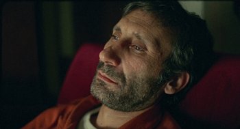 Movie still from “Distant” (2002), directed by Nuri Bilge Ceylan – A person sitting on a chair; Close Up shot, High angle