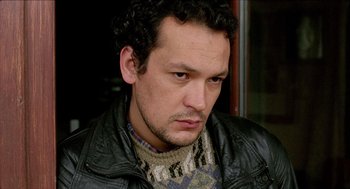 Movie still from “Distant” (2002), directed by Nuri Bilge Ceylan – A person wearing a jacket; Close Up shot, Low angle