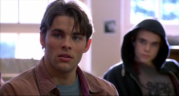 Movie still from “Disturbing Behavior” (1998), directed by David Nutter – A man that is looking at the camera; Close Up shot, Over the shoulder angle