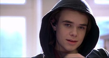 Movie still from “Disturbing Behavior” (1998), directed by David Nutter – A young man wearing a hooded jacket and a pair of headphones; Close Up shot, Over the shoulder angle