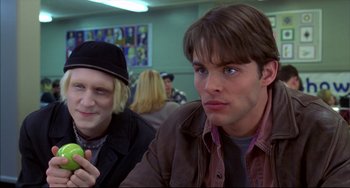 Movie still from “Disturbing Behavior” (1998), directed by David Nutter – Two people sitting at a table in front of a wall; Close Up shot, Over the shoulder angle