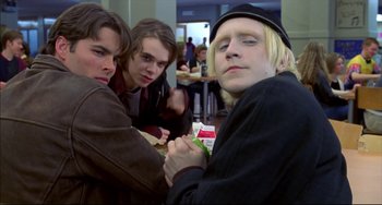 Movie still from “Disturbing Behavior” (1998), directed by David Nutter – A group of young men standing next to each other in a room; Medium shot, Low angle