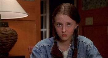 Movie still from “Disturbing Behavior” (1998), directed by David Nutter – A young girl sitting in front of a window; Close Up shot, Over the shoulder angle