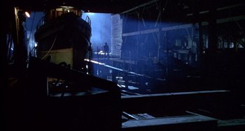 Movie still from “Disturbing Behavior” (1998), directed by David Nutter – A view of a warehouse from the inside of a building; Extreme Wide shot, High angle