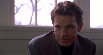 Movie still from “Disturbing Behavior” (1998), directed by David Nutter – A person wearing a suit and tie; Close Up shot, Over the shoulder angle