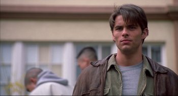 Movie still from “Disturbing Behavior” (1998), directed by David Nutter – A man in a brown jacket is looking at the camera; Close Up shot, Over the shoulder angle