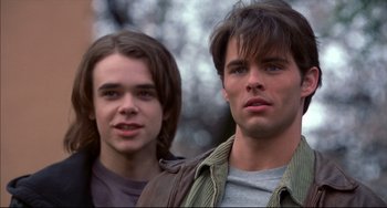 Movie still from “Disturbing Behavior” (1998), directed by David Nutter – Two young men standing next to each other in a forest; Close Up shot, Low angle