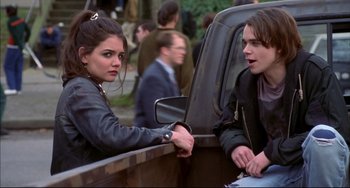 Movie still from “Disturbing Behavior” (1998), directed by David Nutter – A man and a woman sitting in the back of a pick - up truck; Medium shot, Over the shoulder angle