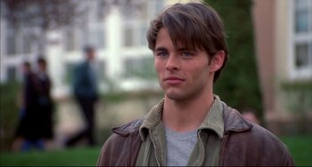 Movie still from “Disturbing Behavior” (1998), directed by David Nutter – A man with long brown hair wearing a brown jacket; Close Up shot, Over the shoulder angle