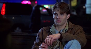 Movie still from “Disturbing Behavior” (1998), directed by David Nutter – A man sitting on a bench at night; Close Up shot, Over the shoulder angle