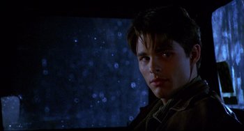 Movie still from “Disturbing Behavior” (1998), directed by David Nutter – A young man is looking into the distance; Close Up shot, Low angle