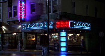Movie still from “Disturbing Behavior” (1998), directed by David Nutter – A man standing on the sidewalk in front of a store; Wide shot, Low angle