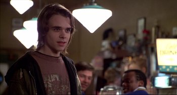 Movie still from “Disturbing Behavior” (1998), directed by David Nutter – A man standing in front of a group of other people; Close Up shot, Over the shoulder angle