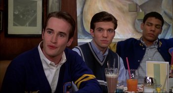 Movie still from “Disturbing Behavior” (1998), directed by David Nutter – Two young men sitting at a table with drinks in front of them; Medium shot, Over the shoulder angle