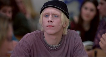 Movie still from “Disturbing Behavior” (1998), directed by David Nutter – A man with blonde hair wearing a black hat; Close Up shot, High angle