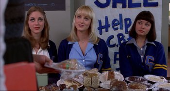 Movie still from “Disturbing Behavior” (1998), directed by David Nutter – Three women sitting at a table covered in food; Medium shot, Over the shoulder angle