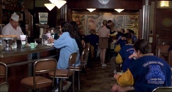 Movie still from “Disturbing Behavior” (1998), directed by David Nutter – A group of people sitting at a restaurant; Wide shot, High angle